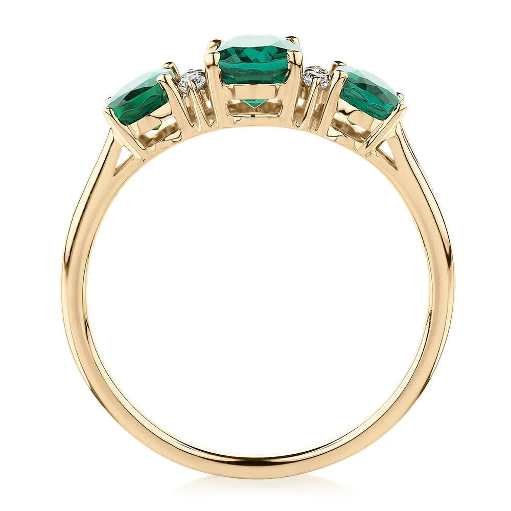 Dress ring with emerald and diamond simulants in 10 carat yellow gold