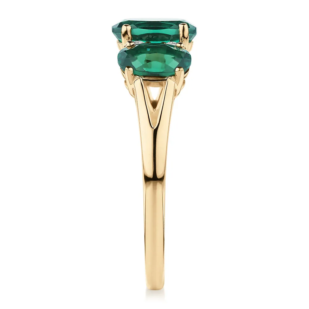 Dress ring with emerald and diamond simulants in 10 carat yellow gold